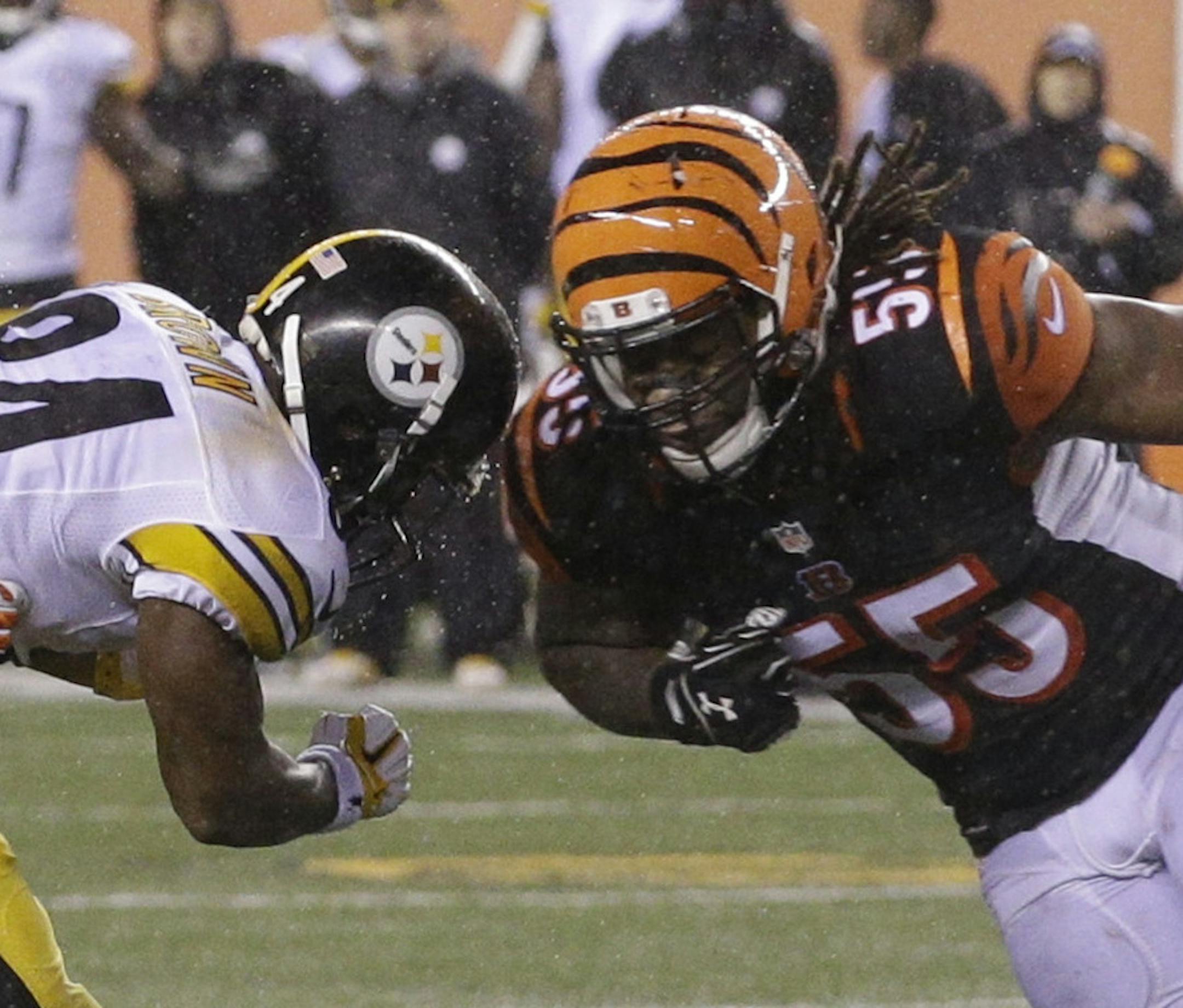 Cincinnati Bengals' Vontaze Burfict (55) runs into Pittsburgh Steelers' Antonio Brown (84) during the second half of an NFL wild-card playoff football game Sunday, Jan. 10, 2016, in Cincinnati. Pittsburgh won 18-16. Burfict was called for a penalty on the play. (AP Photo/John Minchillo)