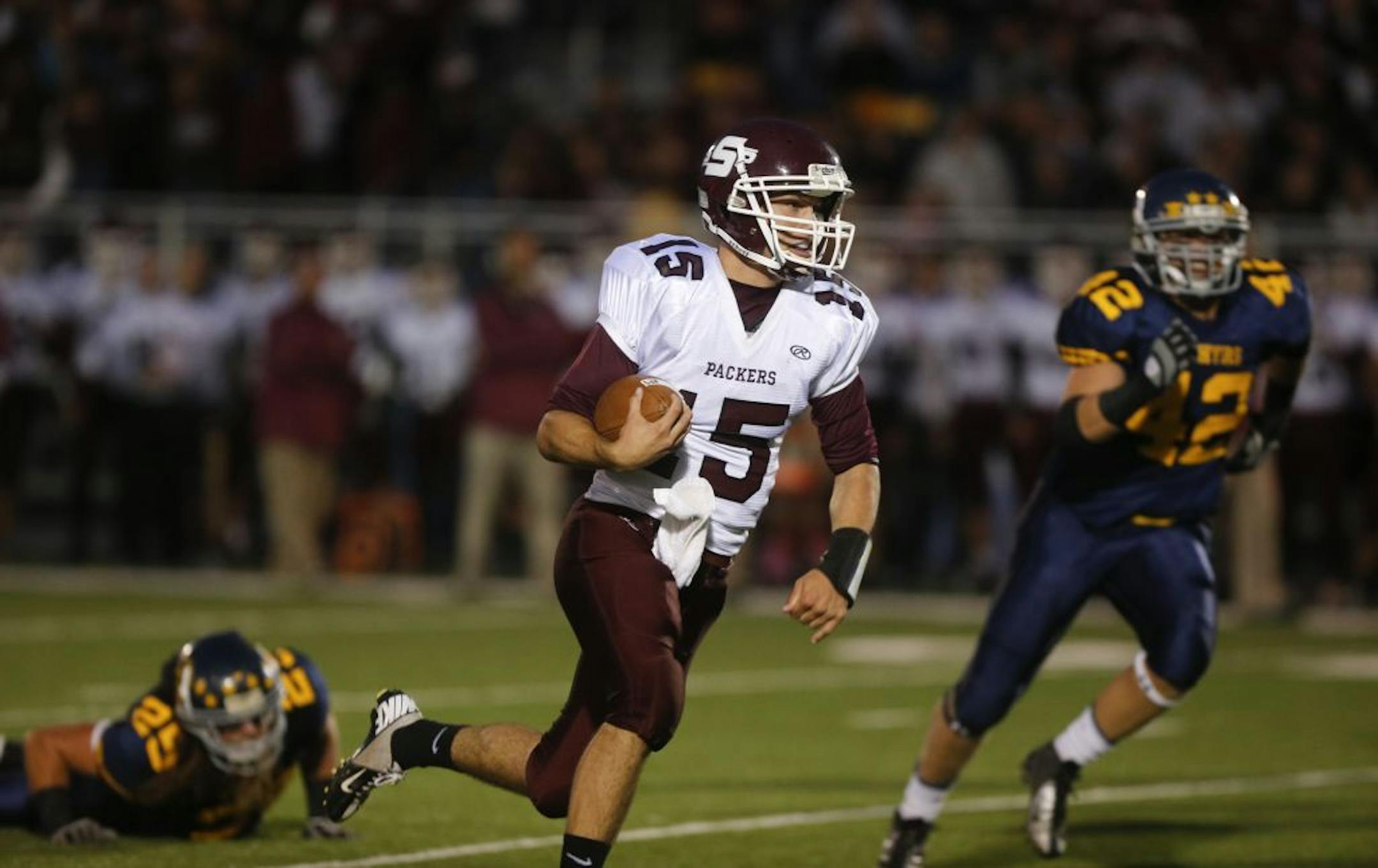 South St. Paul's quarterback Bill Bradecker ran away from Mahtomedi defenders in the first half in Mahtomedi Min., Friday September 21, 2012.