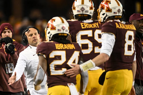Gophers coach P.J. Fleck congratulated players, including running back Mohamed Ibrahim (24), after Ibrahim scored a touchdown in the second half Satur