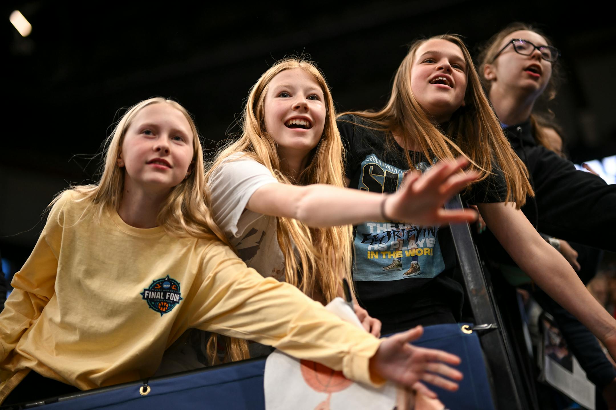 From left, Bailey Johnson,12, Olivia Hammer, 12, and Avery Frier, 13, friends and basketball teammates from New Ulm, vie for the attention of Uconn players leaving the court after a Final Four open practice held Saturday, April 2, 2022 at Target Center in Minneapolis, Minn.