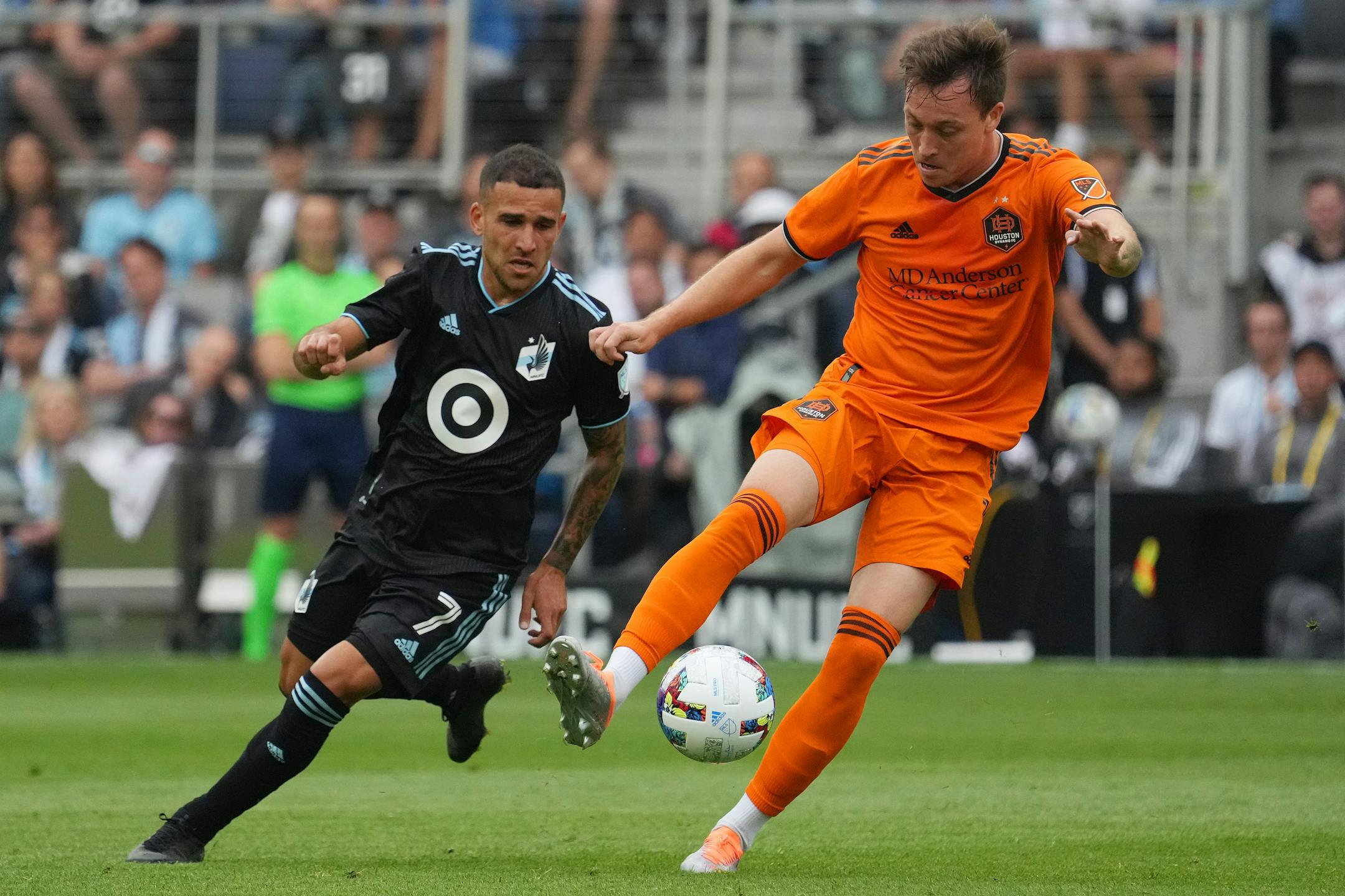 Houston Dynamo forward Corey Baird (11) takes the ball past Minnesota United midfielder Franco Fragapane (7) in the first half of an MLS game between Minnesota United and the Houston Dynamo.