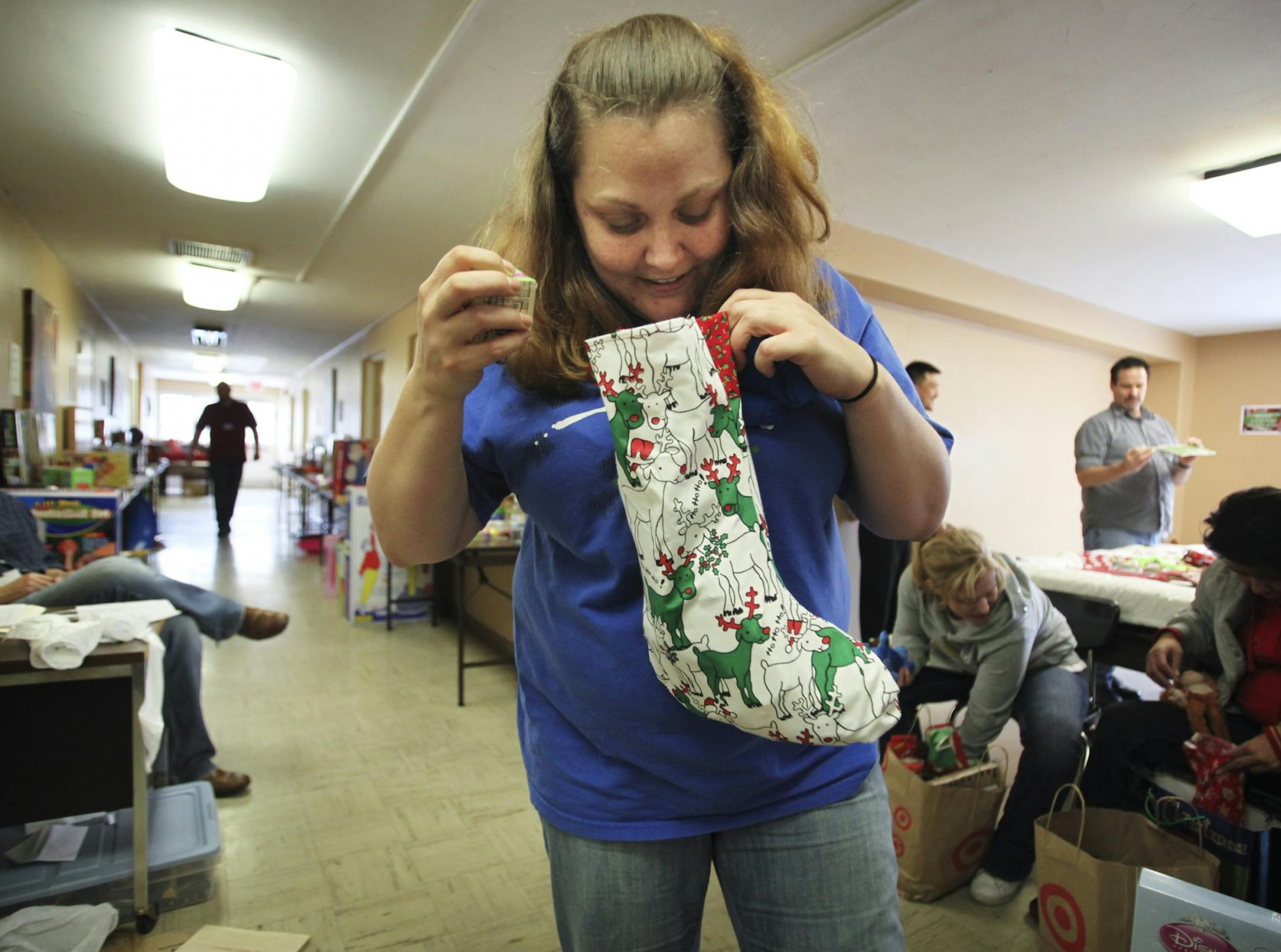Tonya Hipsig checked out one of the stockings she chose for her children at a Minnesota Adult and Teen Challenge recovery center in Minneapolis.