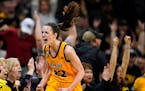 Iowa guard Caitlin Clark celebrates after making a 3-point basket during the first half of an NCAA college basketball game against Michigan, Sunday, F