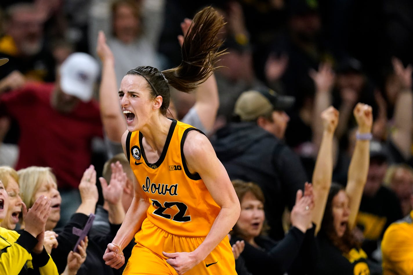 Iowa guard Caitlin Clark celebrates after making a 3-point basket during the first half of an NCAA college basketball game against Michigan, Sunday, Feb. 27, 2022, in Iowa City, Iowa. (AP Photo/Charlie Neibergall)