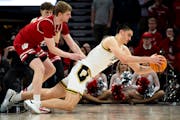 Purdue center Zach Edey falls to the floor as he's defended by Wisconsin's Steven Crowl on Saturday.