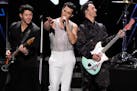 Nick Jonas, left, Joe Jonas and Kevin Jonas perform at Z100’s iHeartRadio Jingle Bal in New York on Dec. 10, 2021. 