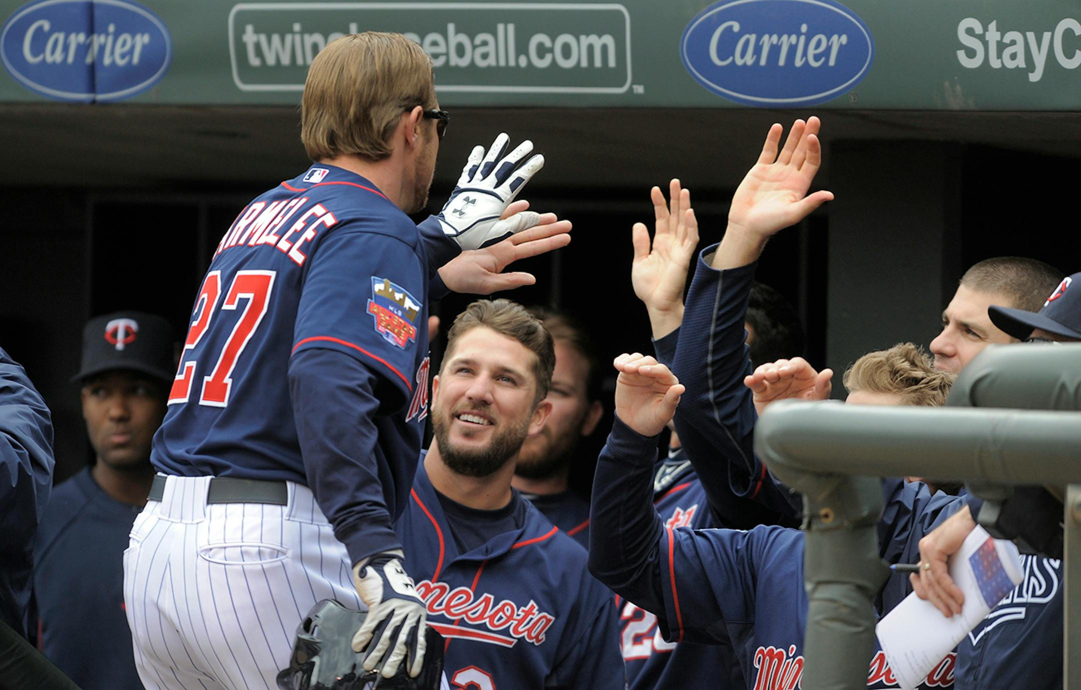 Minnesota Twins� Chris Parmelee gets congratulated in the dugout after hitting a two-run home run during the second inning of a baseball game against the Boston Red Sox, in Minneapolis, Thursday, May 15, 2014.
