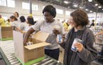 Volunteers from Reading Partners helped pack FoodRx boxes. Boxes may vary to accommodate Somali and Hispanic preferences. "People are looking forward 
