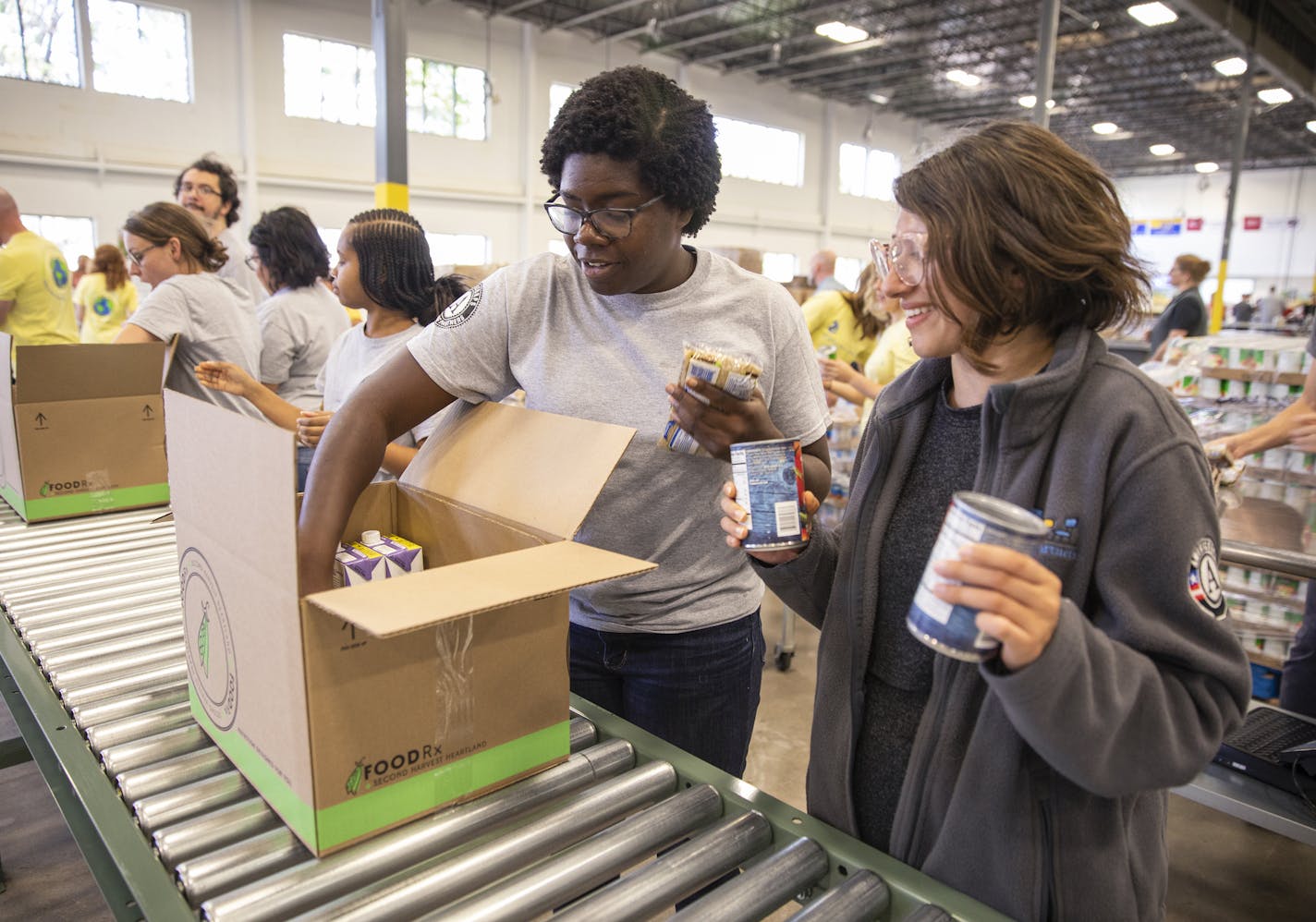 Volunteers from Reading Partners helped pack FoodRx boxes. Boxes may vary to accommodate Somali and Hispanic preferences. "People are looking forward to the boxes," said Kristen Williamson, a Second Harvest dietitian.