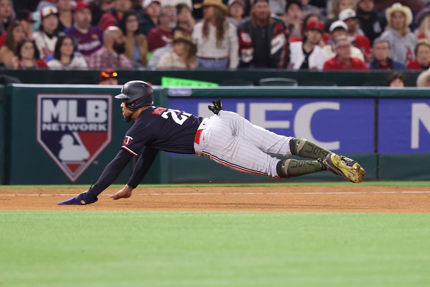 Minnesota Twins designated hitter Byron Buxton (25) slid safely into third base on a single by Kyle Farmer during the fourth inning of a baseball game against the Los Angeles Angels in Anaheim, Calif., Saturday, May 20, 2023. (AP Photo/Jessie Alcheh)