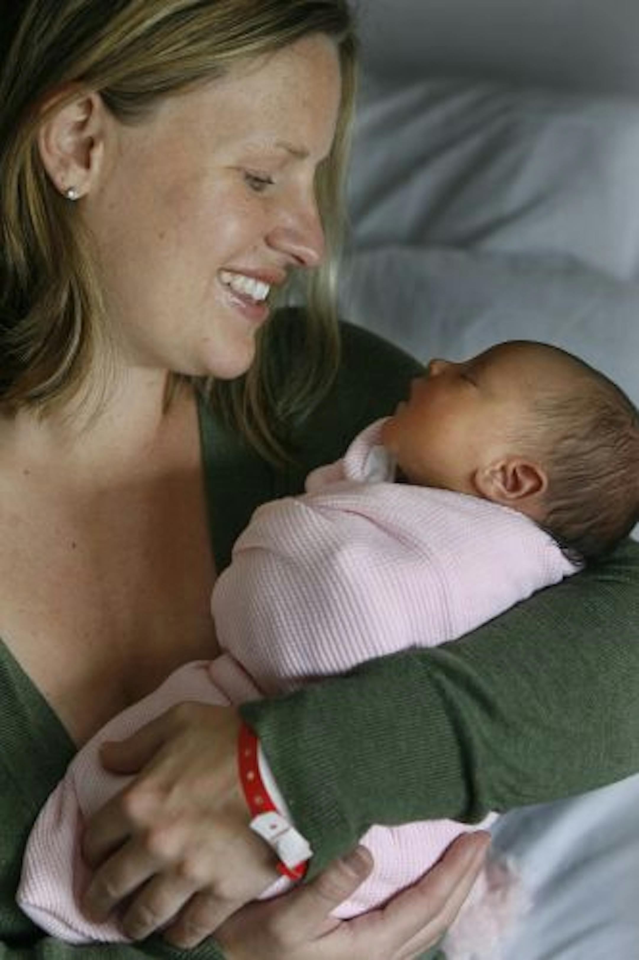 Brooklyn Park mother Laura Davis snuggled with her newborn baby girl Aaliyah at North Memorial Hospital. She makes baby number two for Davis.