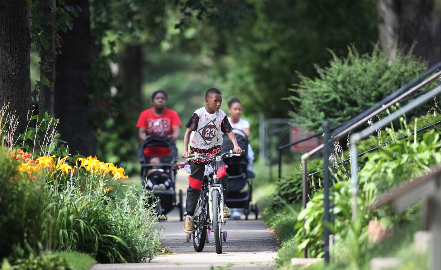 Travion Myles 11, rode his bike on the sidewalk of Irving Avenue N, between 30th and 36th street Thursday August 2, 2018 in Minneapolis, MN. ] JERRY HOLT &#xef; jerry.holt@startribune.com