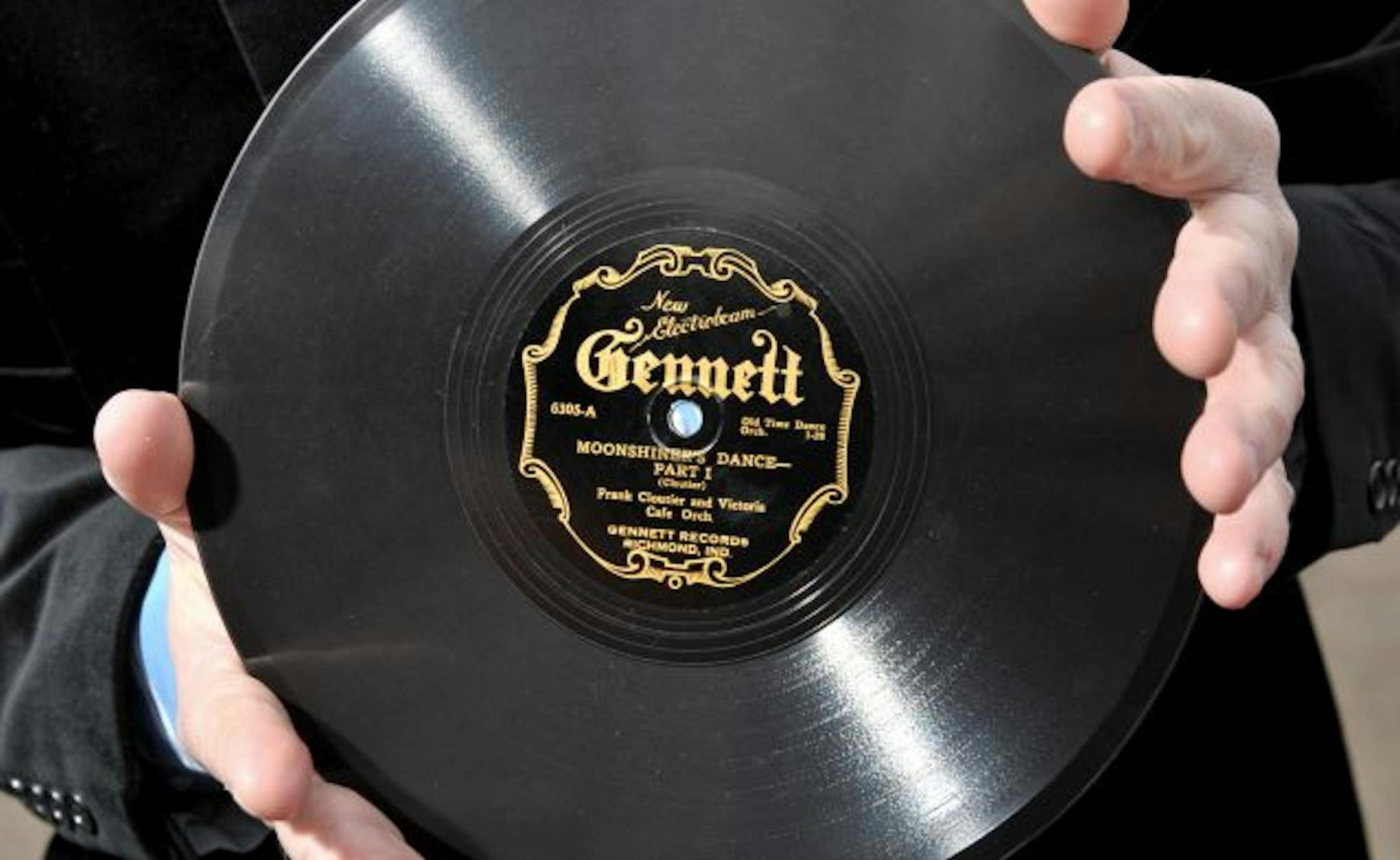Kurt Gegenhuber held an original 78 rpm record of "Moonshiner's Dance Part One" by Frank Cloutier and the Victoria Cafe Orchestra.