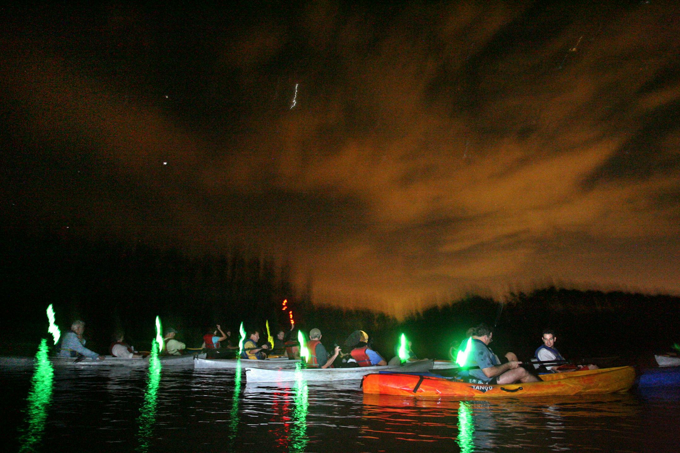 Paddlers gather in the Mosquito Lagoon on the Indian River while on 'A Day Away Outfitters' Bioluminescent Kayak Tour.