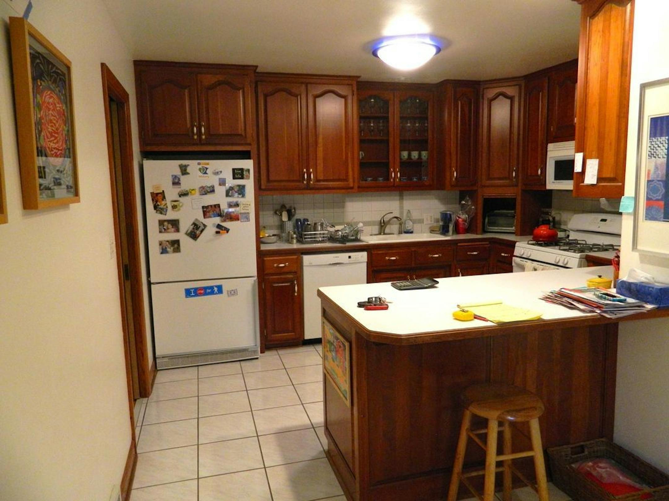 BEFORE Tired dark stained cabinets and tile floor