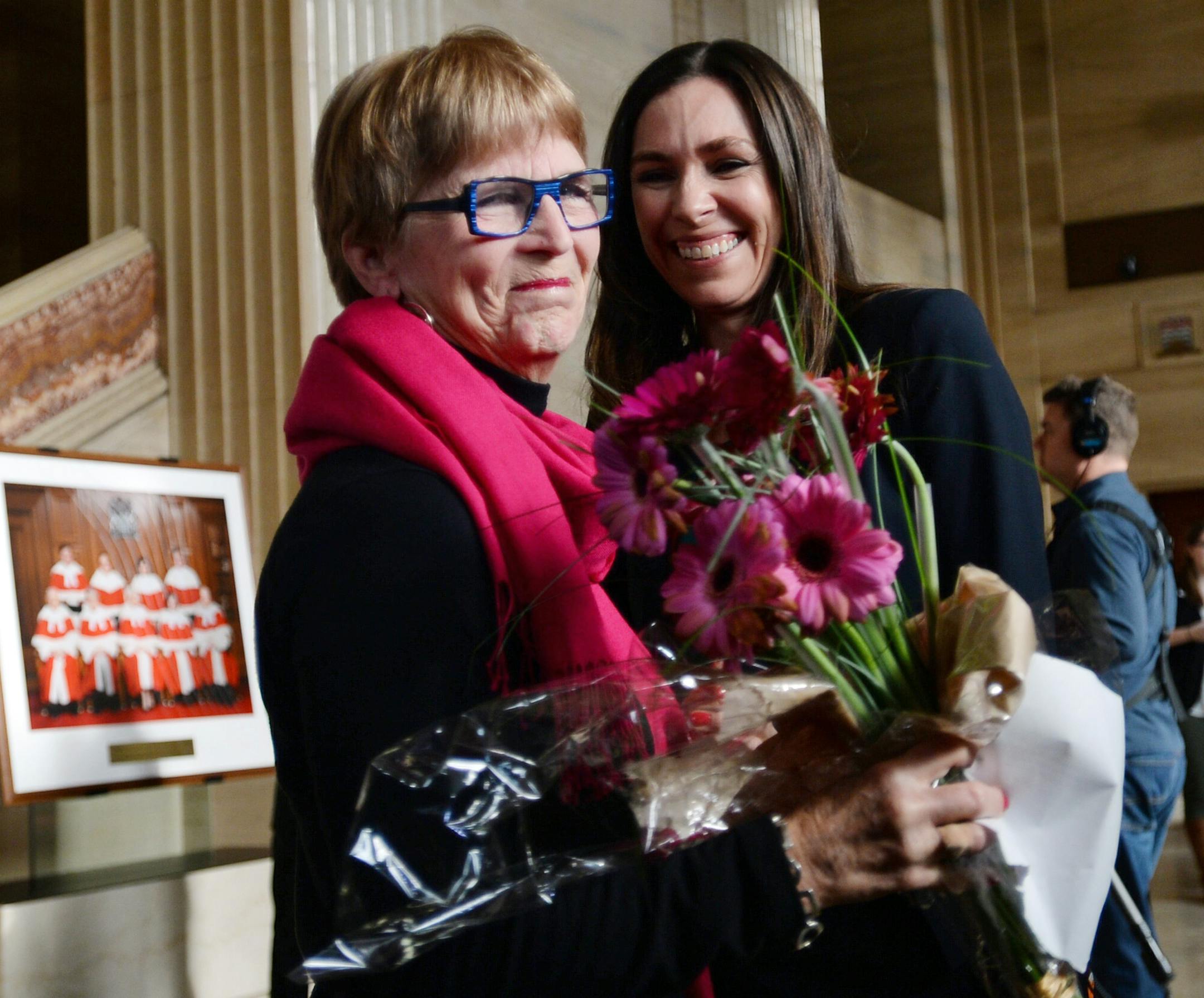 Lee Carter, left, and Grace Pastine, litigation director of the British Columbia Civil Liberties Association, smile inside The Supreme Court of Canada, Friday morning, Feb. 6, 2015, in Ottawa, Ontario. Canada's highest court Friday, unanimously struck down a ban on doctor-assisted suicide for mentally competent patients with terminal illnesses. Carter and her husband accompanied her 89-year-old mother Kathleen (Kay) Carter, who suffered from spinal stenosis, to Switzerland in 2010 where assisted