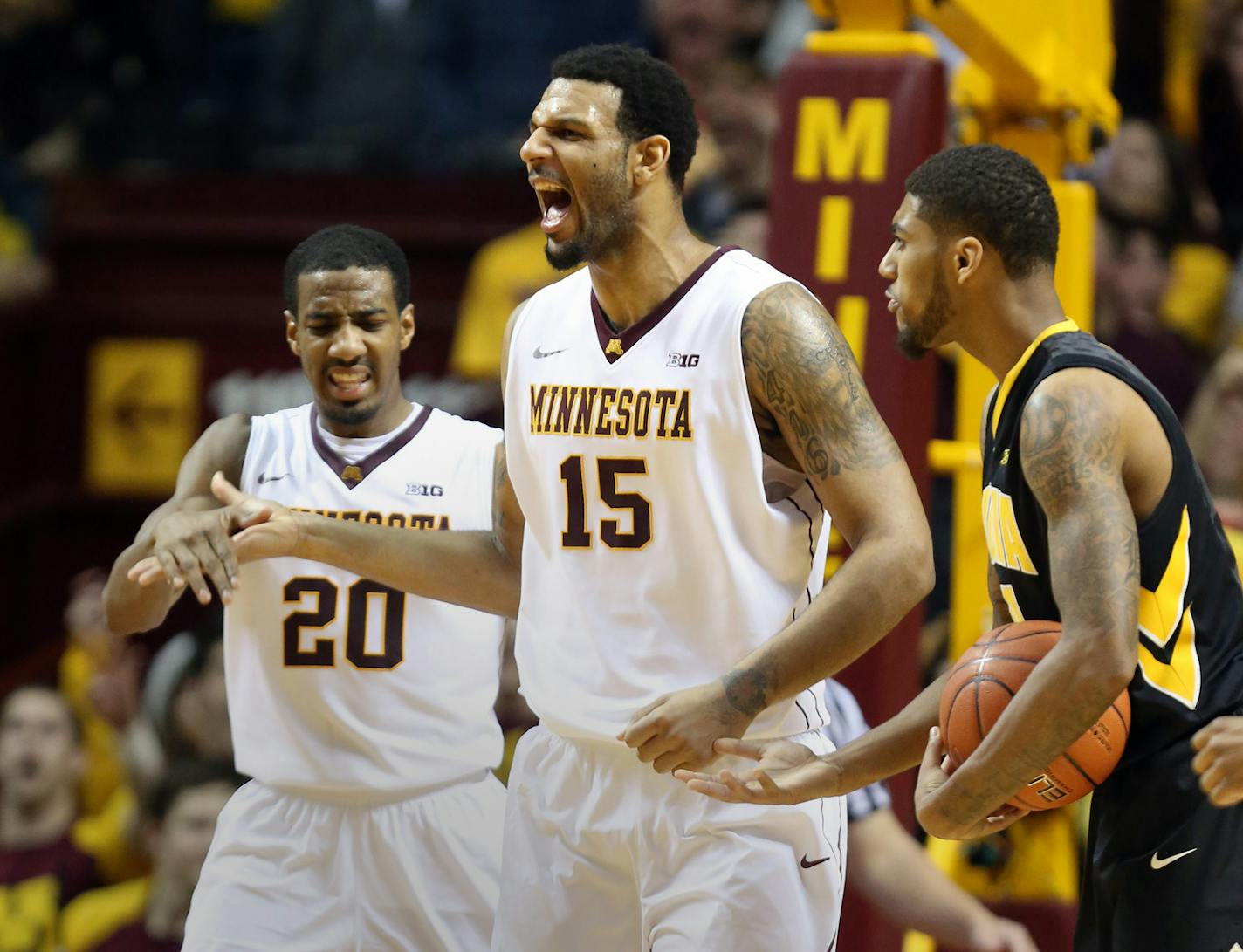 Maurice Walker celebrated with Austin Hollins after their double team caused Iowa's Roy Devyn Marble to travel during the second half at Williams Arena on Tuesday, February 25, 2014.