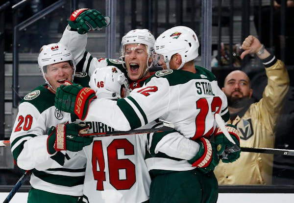 Charlie Coyle, center, was met by teammates after scoring the go-ahead goal in the third period. Jared Spurgeon and Eric Staal, right, assisted.