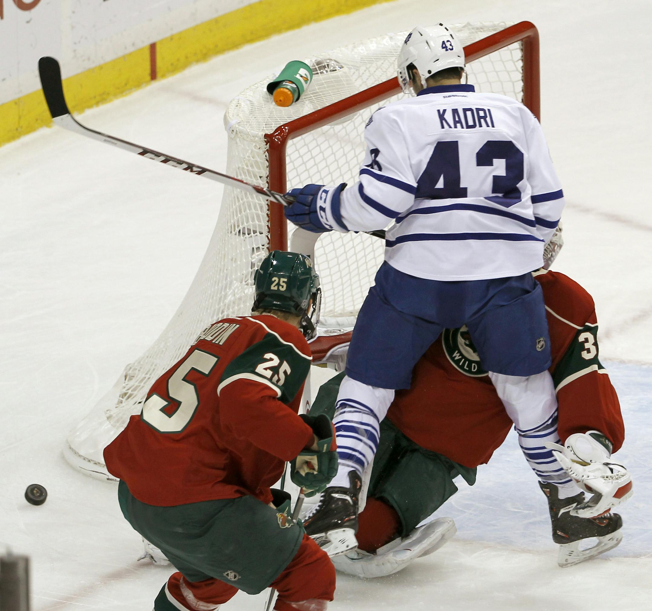 Toronto Maple Leafs center Nazem Kadri (43) collides with Minnesota Wild goalie Niklas Backstrom, of Finland, during the first period of an NHL hockey game in St. Paul, Minn., Wednesday, Nov. 13, 2013. Backstrom left the game later in the period. (AP Photo/Ann Heisenfelt)