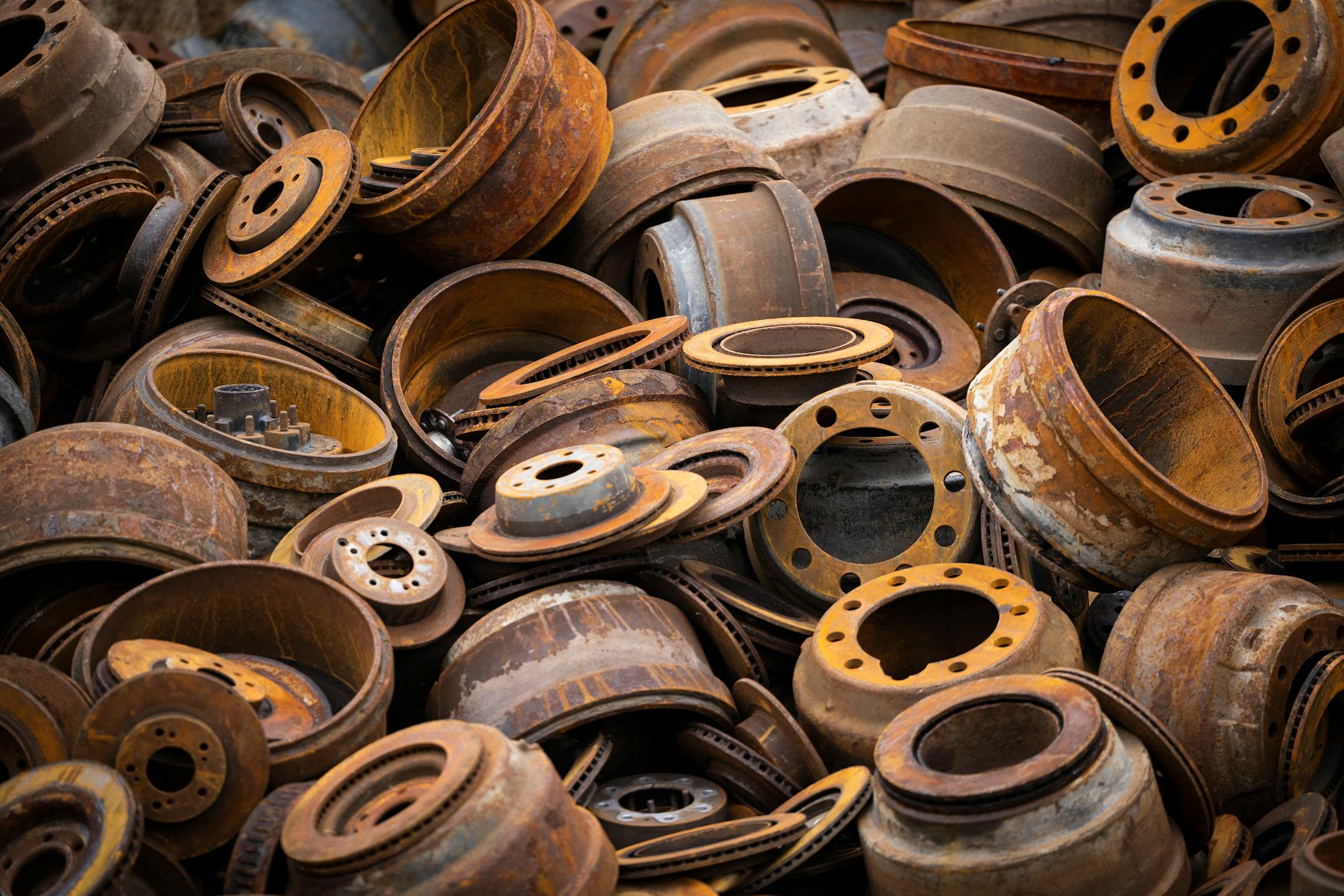 Wheel parts are piled outside the metal recycling facility.