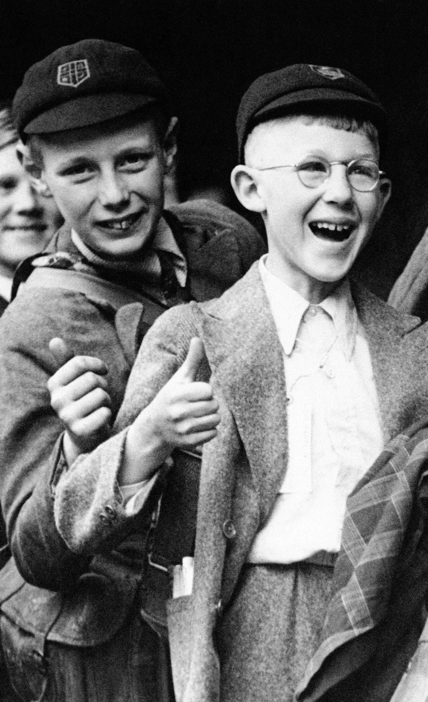 Two youngsters wait their turn to board a train to take them from London into the country as the British capital began its second huge scale evacuation of school children, June 13, 1940. The move was made when Adolf Hitler&#xed;s total war turned its threat to the England shore. The boys display the Thumbs Up gesture made popular by the RAF. (AP Photo) ORG XMIT: APHS341052