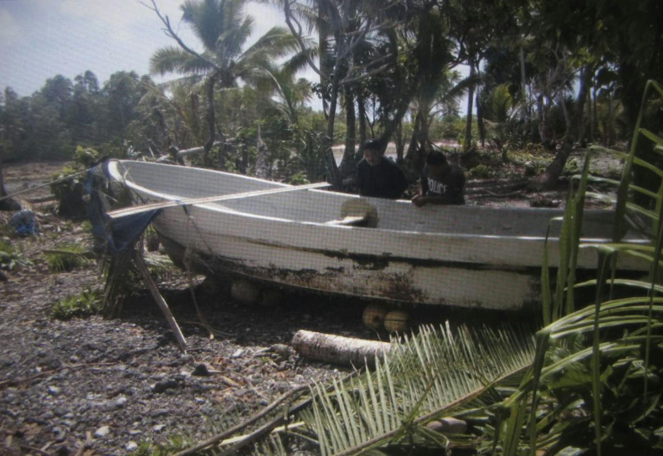 In this Monday, Feb. 3, 2014 photo shown on a tablet device and released by Willing Kajidrik of the Marshall Islands Sea Patrol on Sunday, Feb. 9, 2014, police check a 7-meter fishing boat of Jose Salvador Alvarenga after it was pulled onto the shore following his rescue, on Marshall Islands.