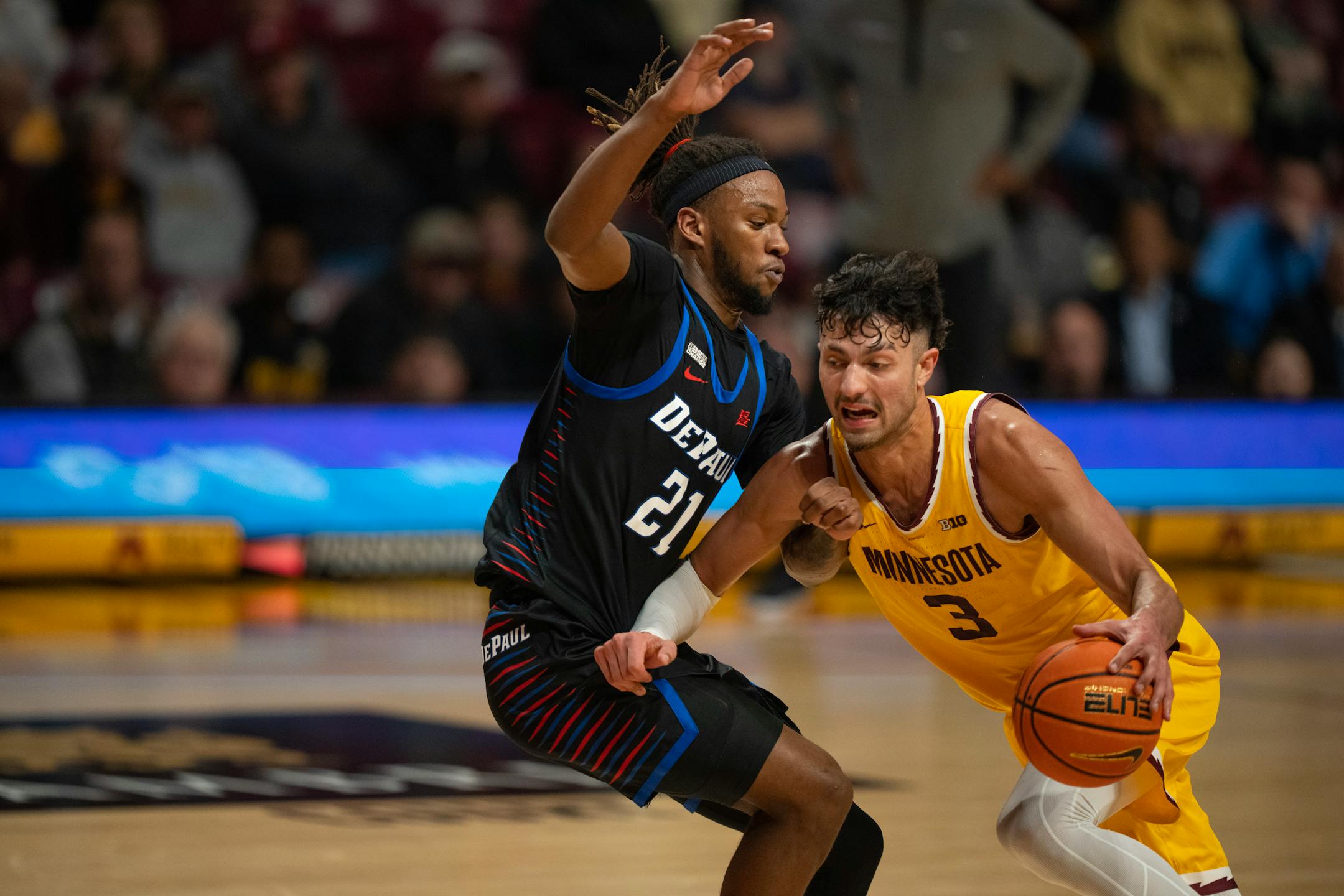 Minnesota Gophers forward Dawson Garcia (3) drove against DePaul Blue Demons forward Da'Sean Nelson (21) in the second half.