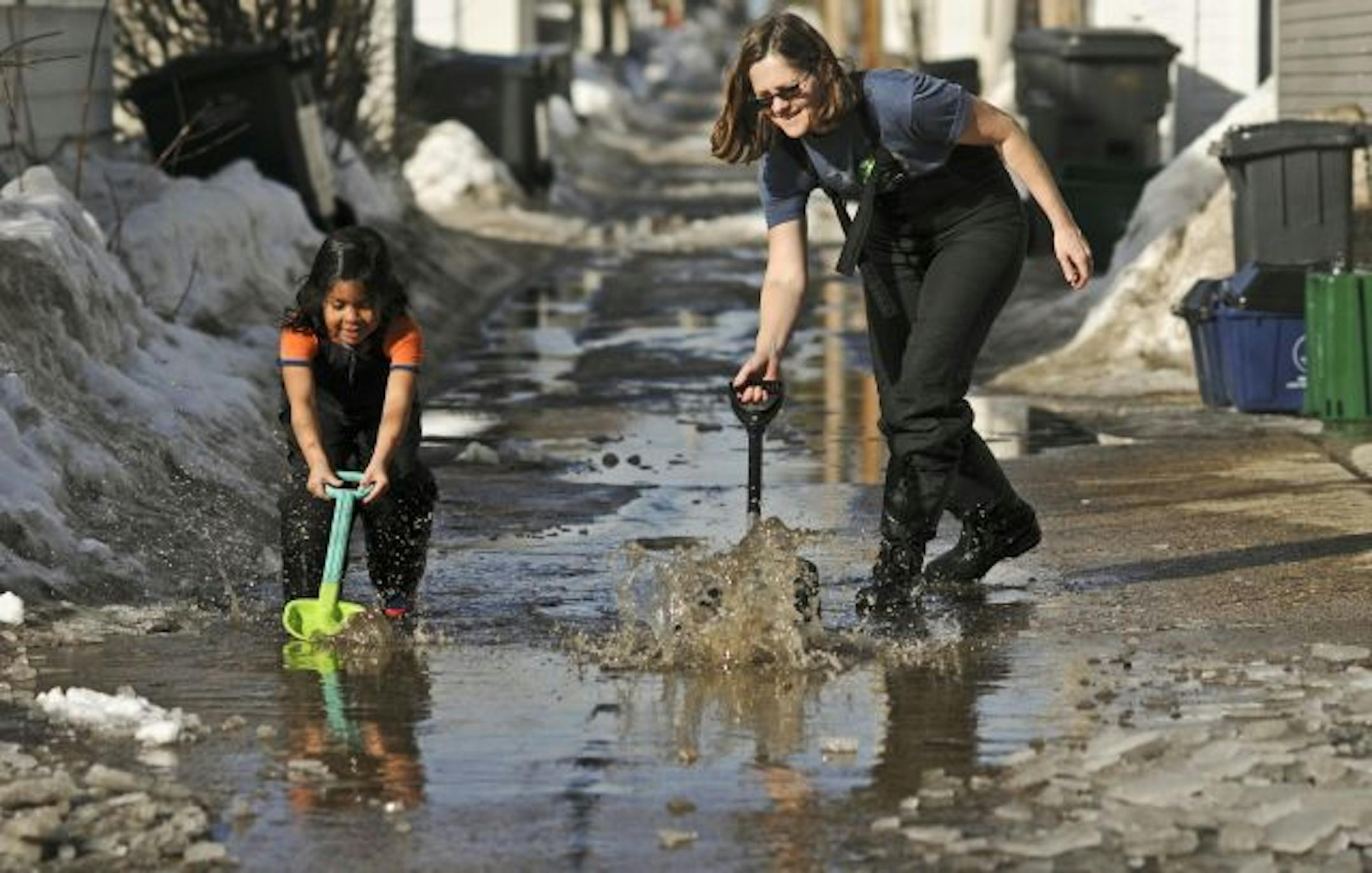 Was it work or was it play? Regardless, Tori Sadler and her 5-year-old daughter, Karina Sadler-Sfikas, sent some former snow and ice on its way down the alley near their house on Harriet Avenue S. on Sunday.
