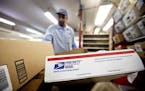 FILE - In this Feb. 7, 2013 file photo, packages wait to be sorted in a Post Office in Atlanta. The U.S. Postal Service said Thursday, Feb. 9, 2017, i