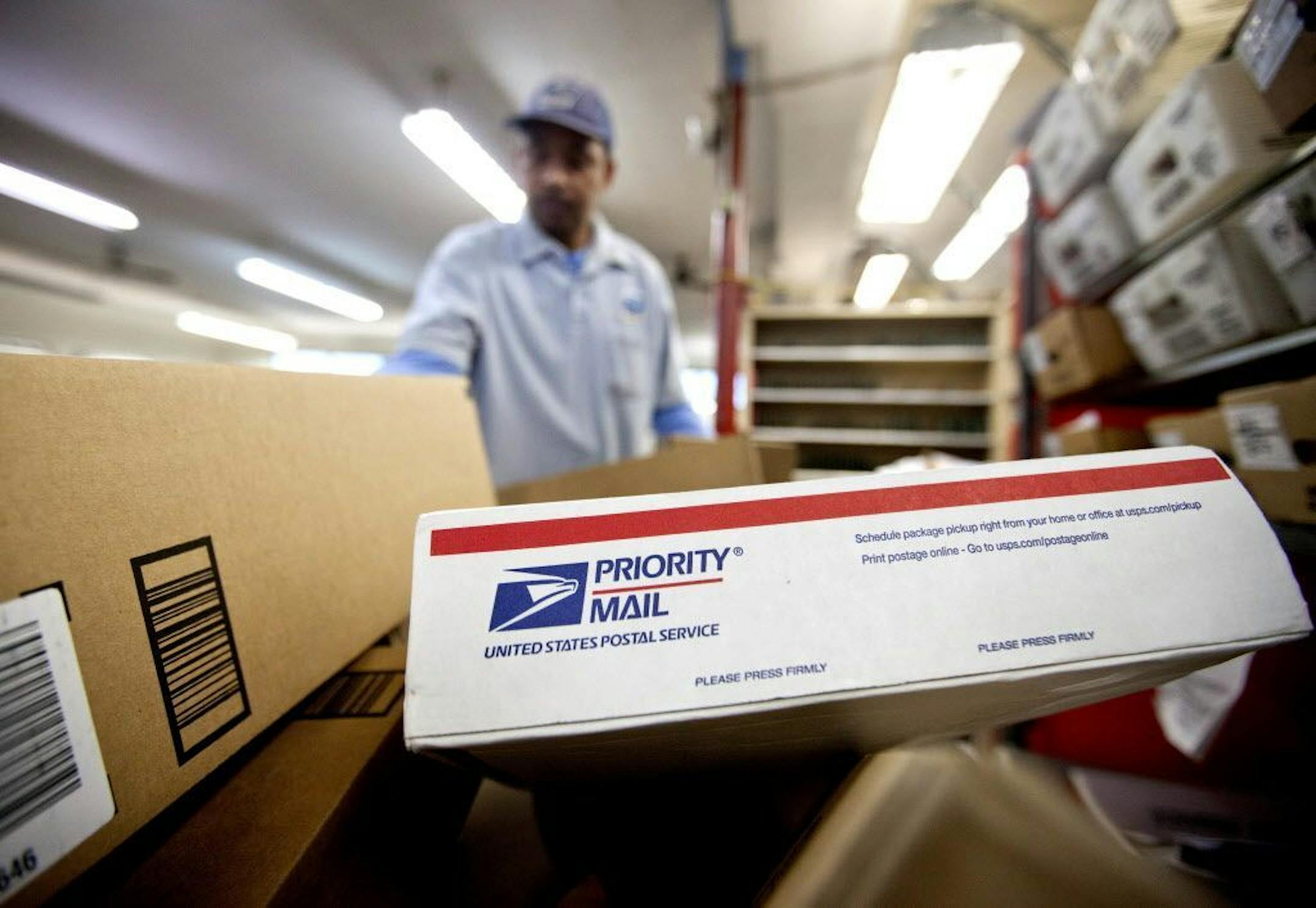 FILE - In this Feb. 7, 2013 file photo, packages wait to be sorted in a Post Office in Atlanta. The U.S. Postal Service said Thursday, Feb. 9, 2017, it lost $200 million during the year-end holiday season, despite a strong quarter of package shipping and expanded use of vote-by-mail in the November presidential election.