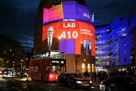 An exit poll predicting that the Labour Party led by Keir Starmer will win 410 seats in Britain's general election is projected onto BBC Broadcasting 