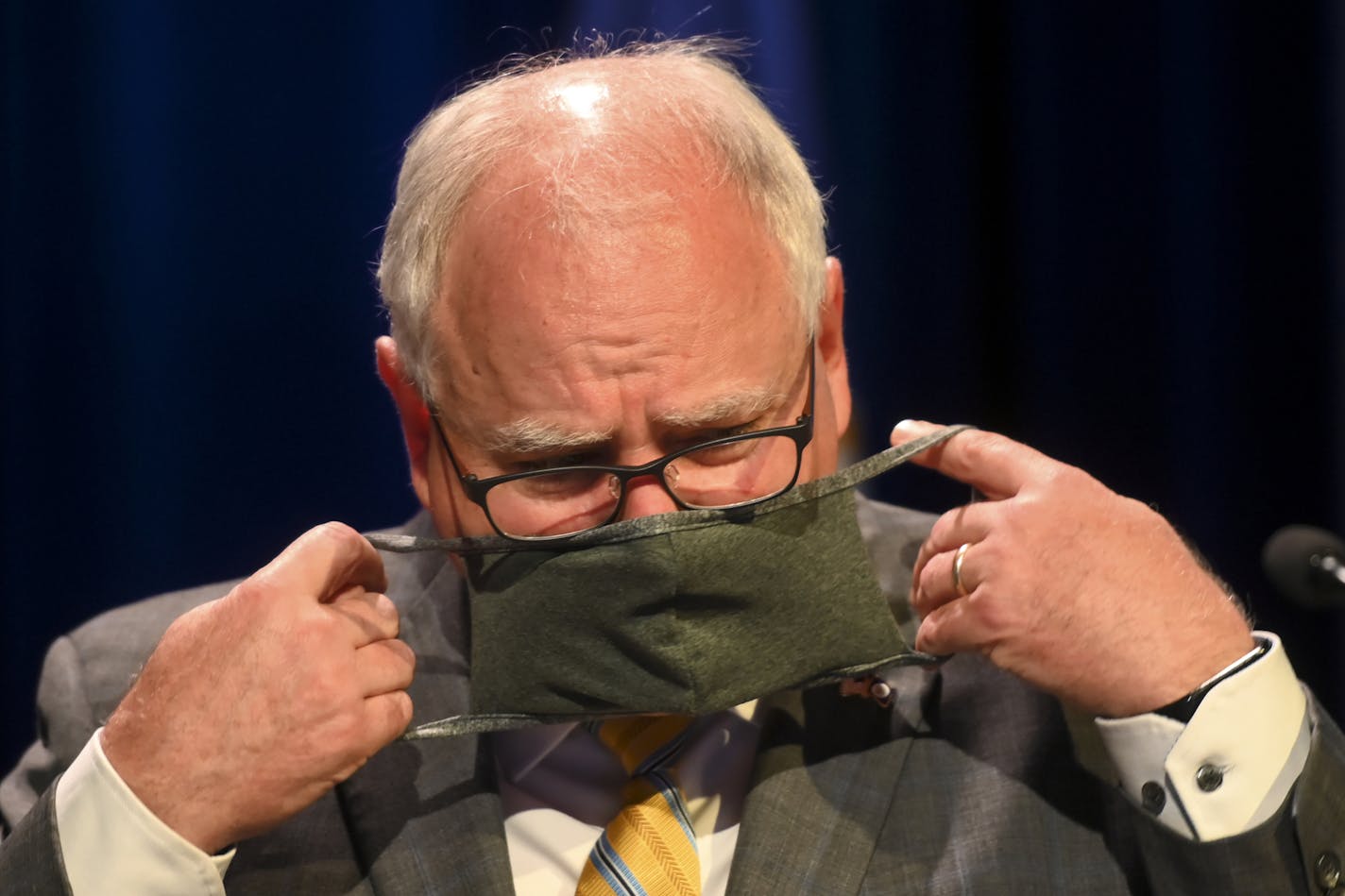 Minnesota Gov. Tim Walz put his face mask at the conclusion of a press conference Thursday, July 30, 2020 announcing the learning plan for Minnesota schools for the upcoming 2020-21 school year. (Aaron Lavinsky/Star Tribune via AP, Pool)