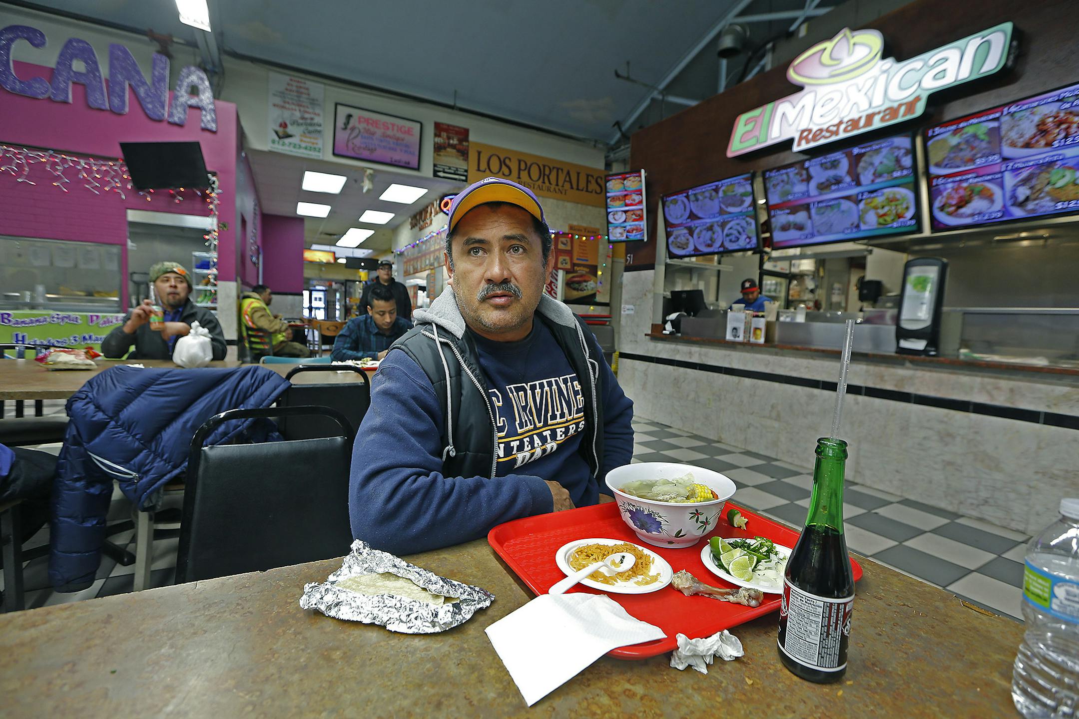 Gustavo Tapia ate lunch as he watched CNN in Spanish as they listened to news regarding President Trump's executive orders enabling construction of his proposed wall on the U.S.-Mexico border and targeting cities where local leaders refuse to hand over illegal immigrants for deportation, at Lake Plaza, Wednesday, January 25, 2017 in Minneapolis, MN. ] (ELIZABETH FLORES/STAR TRIBUNE) ELIZABETH FLORES &#x2022; eflores@startribune.com