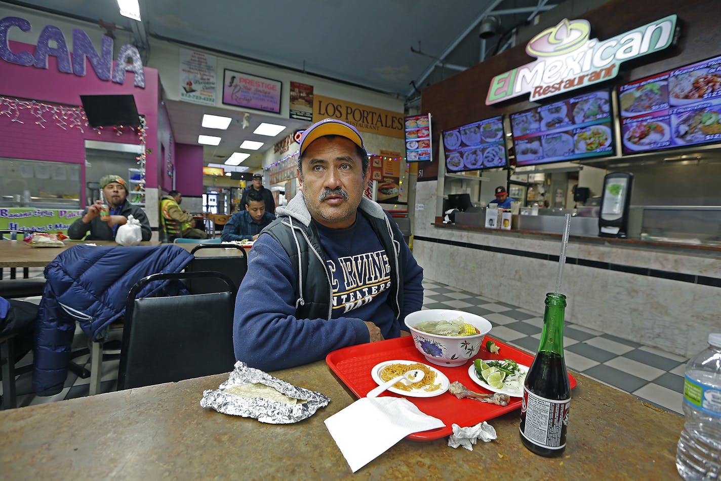 Gustavo Tapia ate lunch as he watched CNN in Spanish as they listened to news regarding President Trump's executive orders enabling construction of his proposed wall on the U.S.-Mexico border and targeting cities where local leaders refuse to hand over illegal immigrants for deportation, at Lake Plaza, Wednesday, January 25, 2017 in Minneapolis, MN. ] (ELIZABETH FLORES/STAR TRIBUNE) ELIZABETH FLORES &#x2022; eflores@startribune.com