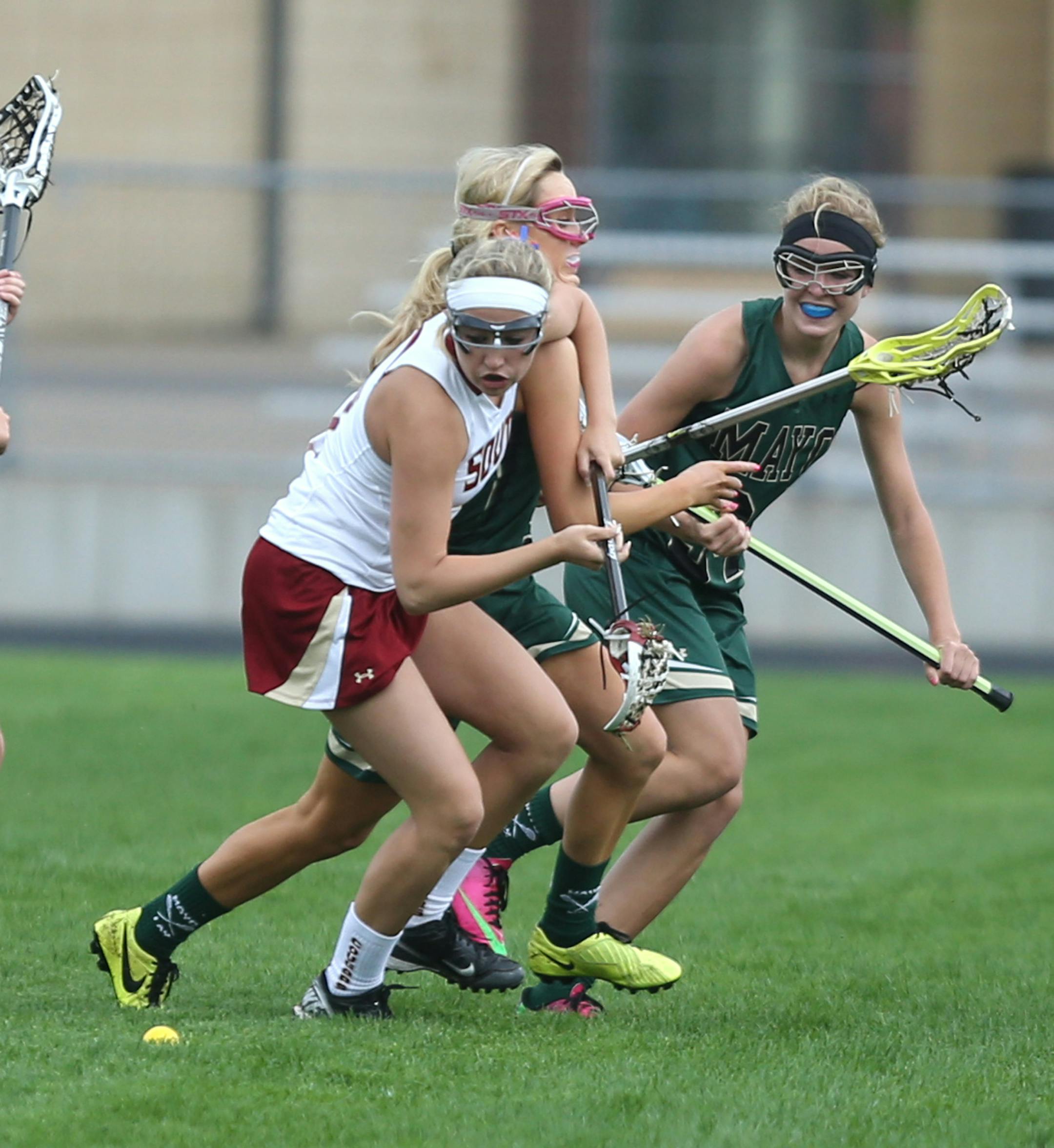 Lakeville South's Brooke Galle muscled the Rochester Mayo Ellison Stead out of the way for the ball. ] (KYNDELL HARKNESS/STAR TRIBUNE) kyndell.harkness@startribune.com Lakeville South vs Rochester Mayo in Lakeville Min. Tuesday, May 27, 2014.