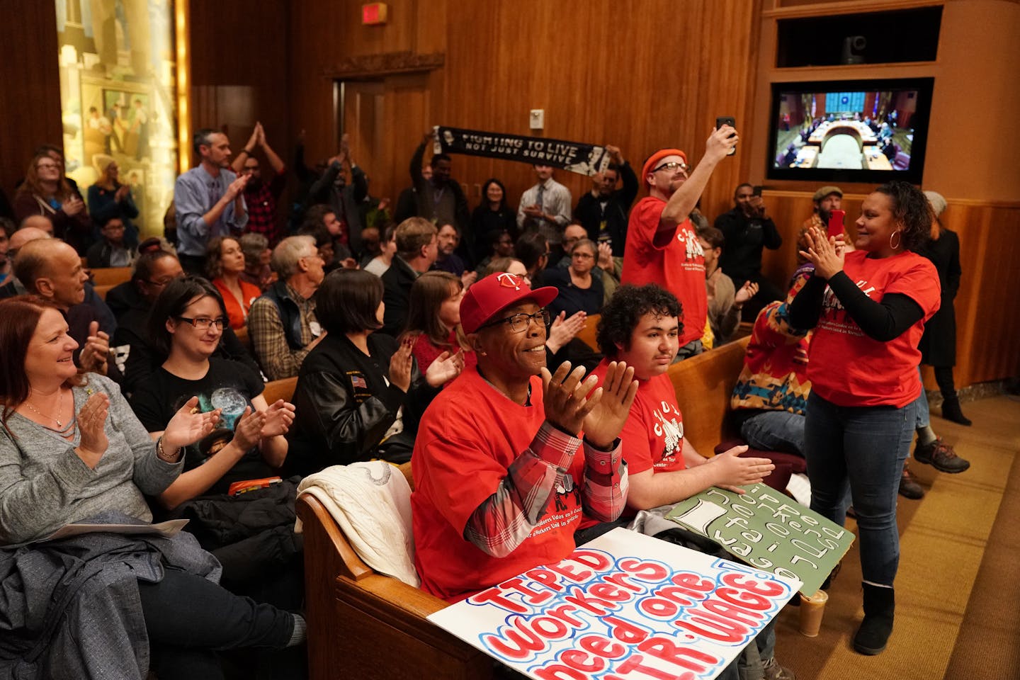 Supporters, including Reggie Wright, center, and Valentina McKenzie, a field organizer with CTUL, Centro de Trabajadores Unidos en la Lucha, right, cheered after the St. Paul City Council voted to pass the $15 minimum wage ordnance Wednesday evening. ] ANTHONY SOUFFLE • anthony.souffle@startribune.com The St. Paul City Council voted to pass a $15 minimum wage on Wednesday, after a year of discussion, then held a signing ceremony with Mayor Melvin Carter Wednesday, Nov. 14, 2018 at City Hall in S