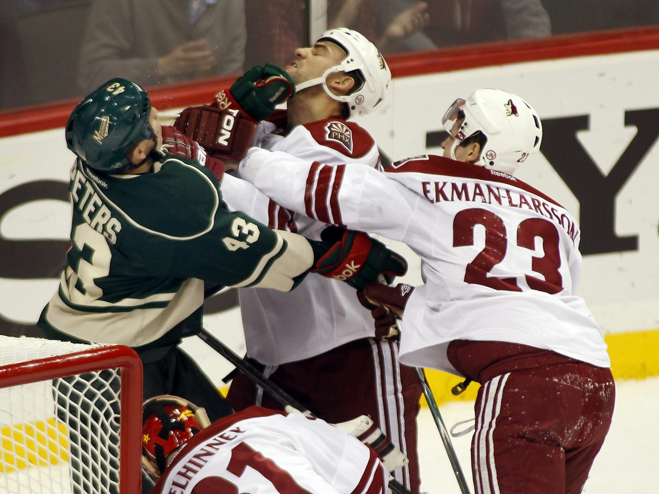 Coyote, Oliver Ekman-Larsson throws a punch at Wild Warren Peters while peters put one on Paul Bissonnette during first period action. Minnesota Wild vs Phoenix Coyotes hockey game.[ TOM WALLACE • twallace@startribune.com _ Assignments # 20029855U_ December 31, 2011_ SLUG: wild0101_ EXTRA INFORMATION: Minnesota hosts phoenix at the Xcel center on New Years Eve.