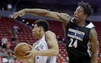 Minnesota Timberwolves' Jarrid Famous fouls Memphis Grizzlies' Wade Baldwin IV during the first half of an NBA summer league basketball game Thursday,