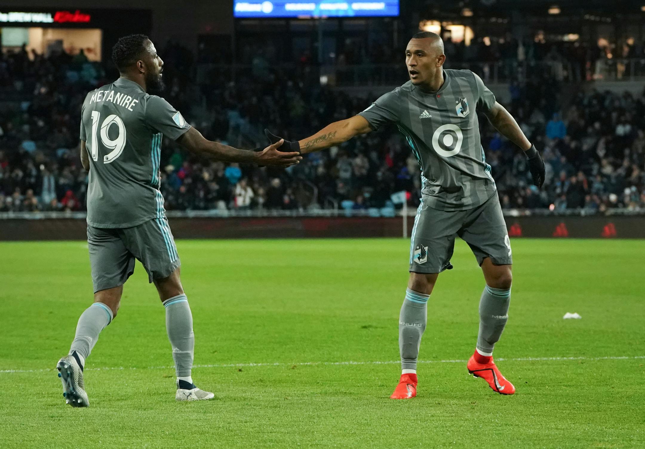 Minnesota United defender Romain Metanire (19) and forward Angelo Rodriguez (9) slapped hands in the second half during a game earlier this month. The Loons won Saturday, 1-0 over Houston.