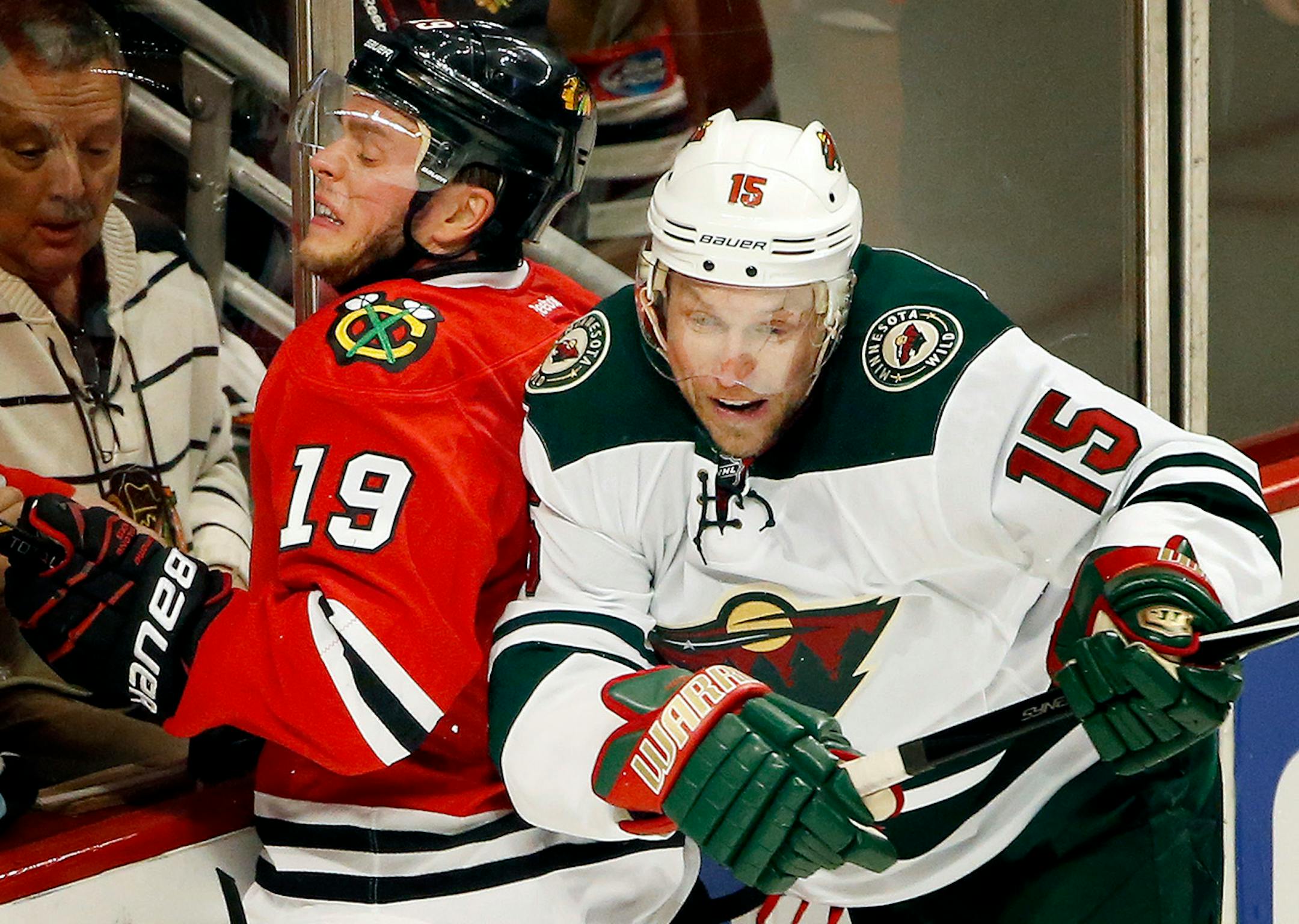 Jonathan Toews (19) and Dany Heatley (15) collided in the second period.