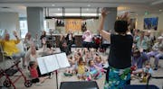 The seniors at Pillars at Prospect Park joined children from the on-site day care to attend a musical event in the community room that Nora Paoli from