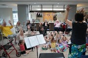 The seniors at Pillars at Prospect Park joined children from the on-site day care to attend a musical event in the community room that Nora Paoli from