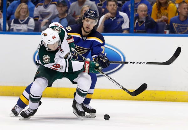 The Wild's Jared Spurgeon missed the puck as the Blues' Vladimir Sobotka defended during the third period of Game 3 on Sunday.