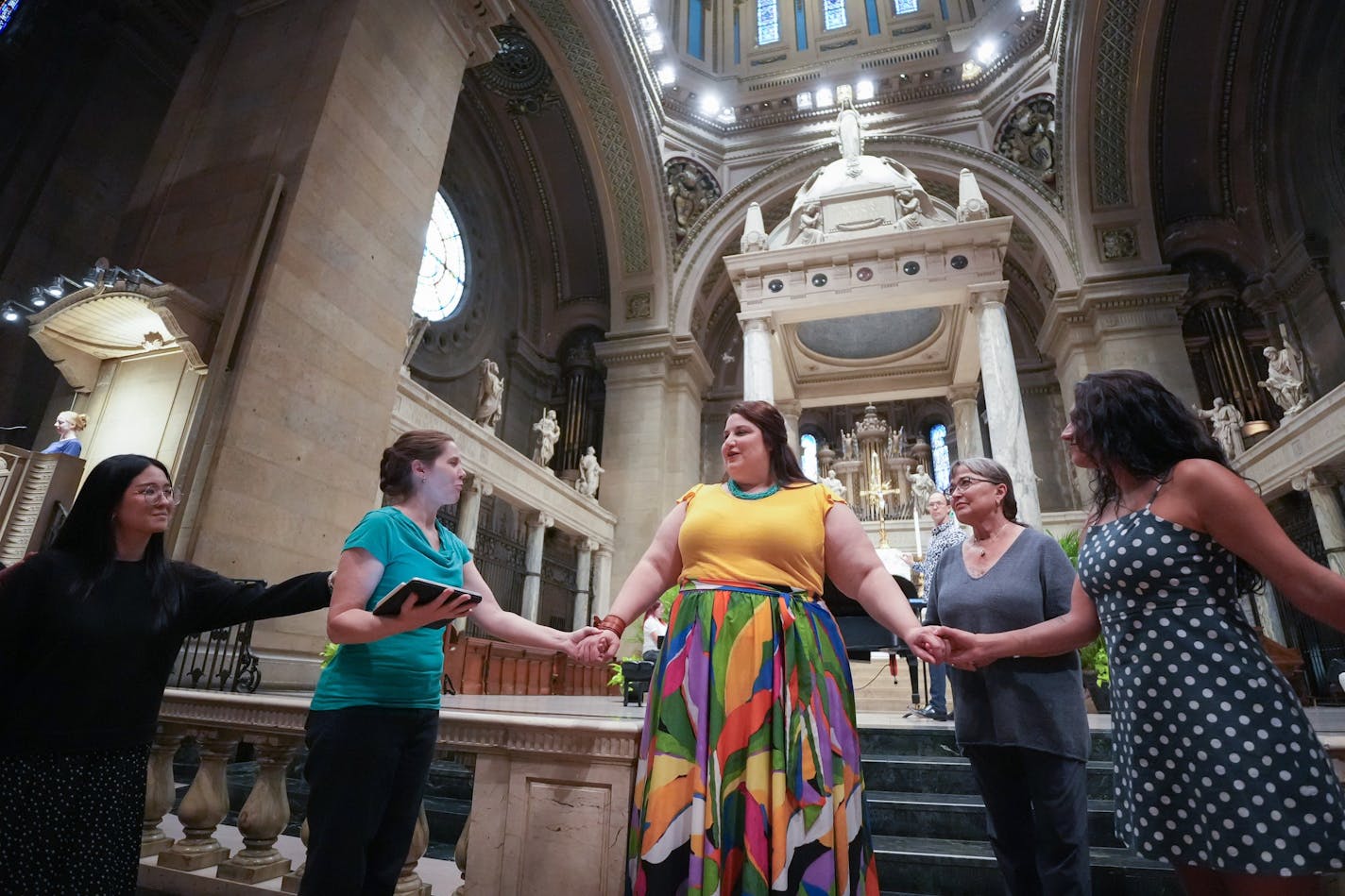 During a rehearsal of Out of the Box Opera's "Suor Angelica" at Minneapolis' Basilica of St. Mary, the title character (Alexandra Loutsion, in yellow top) communes with her fellow nuns. (Photo: Glen Stubbe)