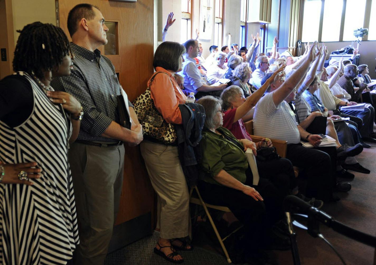 Representatives of Presbyterian churches belonging to the Synod of the Lakes and Prairies in the Twin Cities area vote first by hand, and later by paper ballot, to eliminate the celibacy requirement for gay and lesbian clergy at the Peace Presbyterian Church in St. Louis Park, Minn., Tuesday.