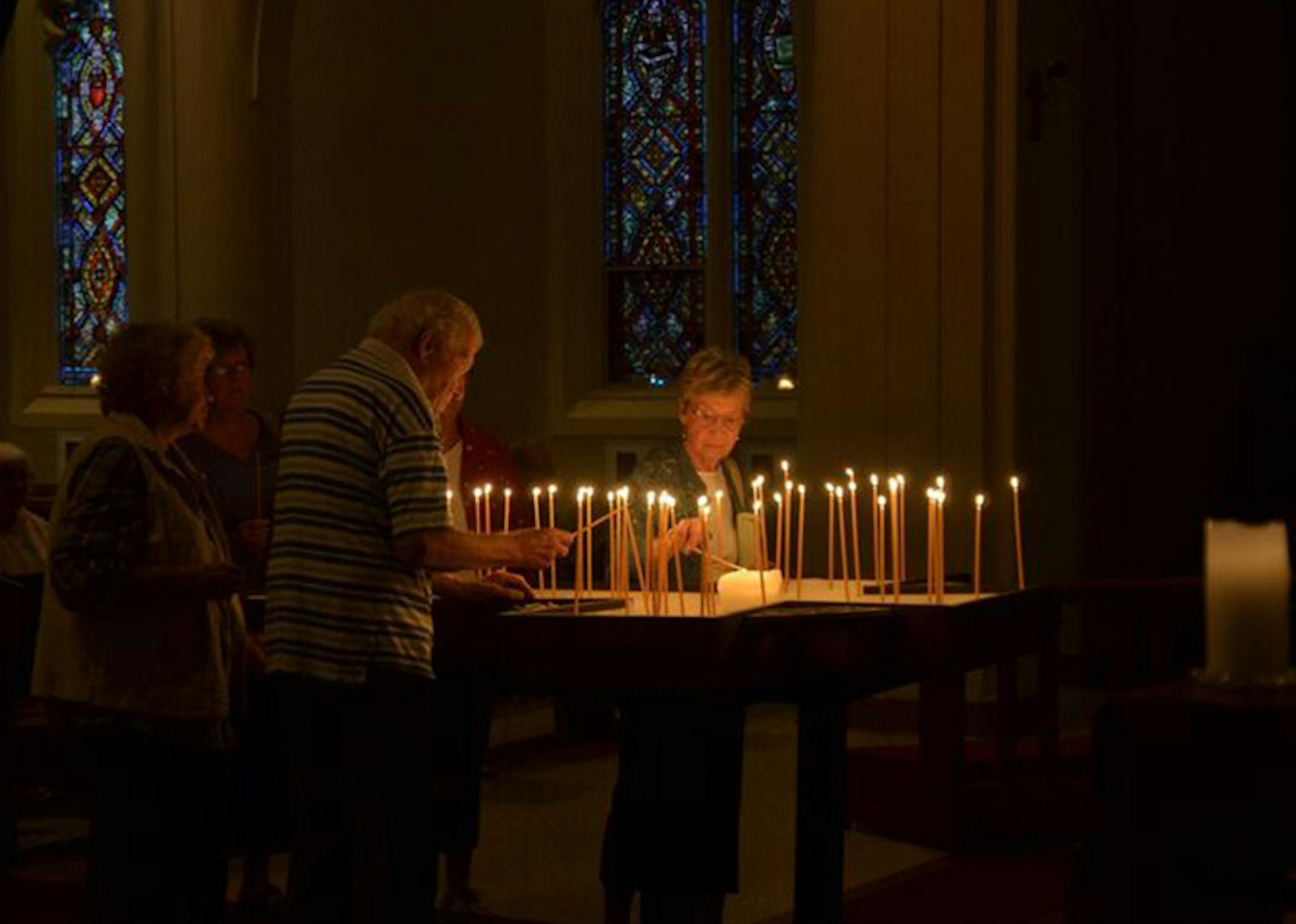 Worshippers light and place candles at the Pilgrim Lutheran Church Celtic contemplative evening service.
Photo by Chuck Regal, Pilgrim Lutheran Church