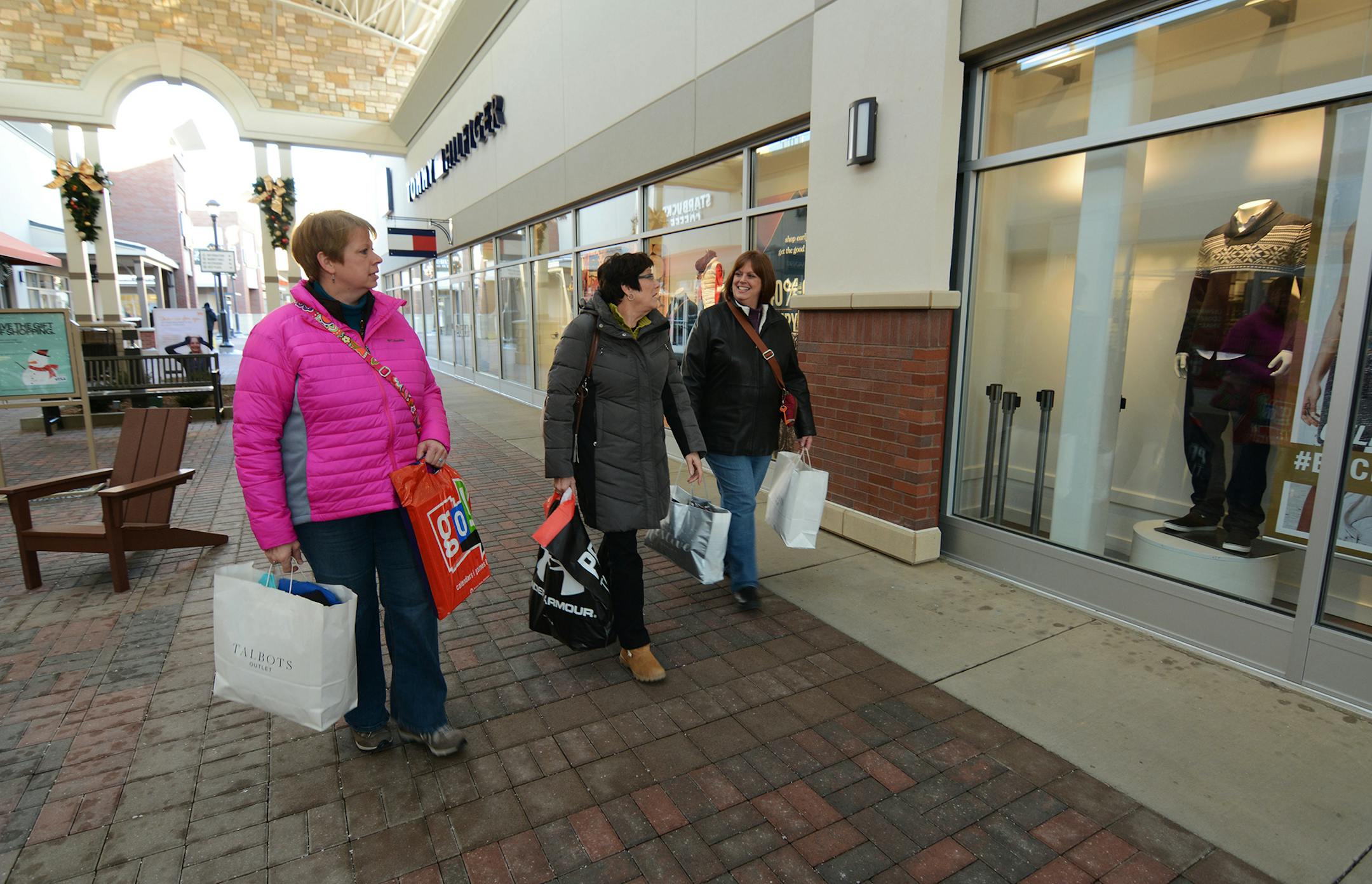 Denise Peterson (pink), Pam Foesch (green), Brenda Peterson (purple) of Hector, Minn. shopped at Twin Cities Premium Outlets, the new outlet mall in Eagan. Photo by Liz Rolfsmeier, Special to the Star Tribune