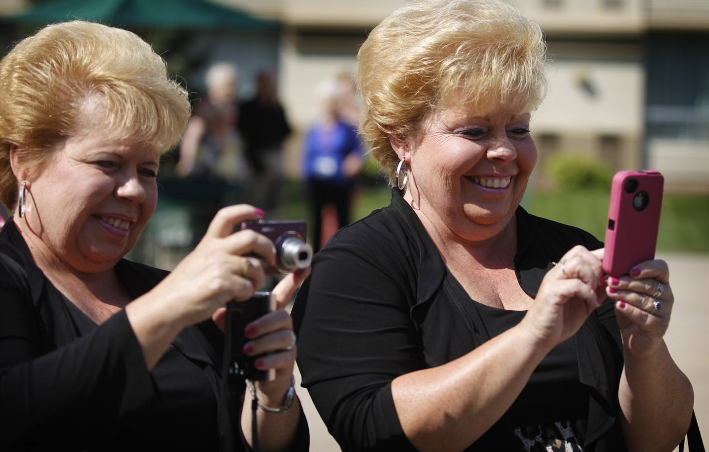 Twin sisters Dianne and Doreen McConaghy of Atlanta took a photo of members of the 2012 International Twins Associations at the airport Marriott in Bloomington on Sunday. Seventy-five sets of Twins attended this year's event.