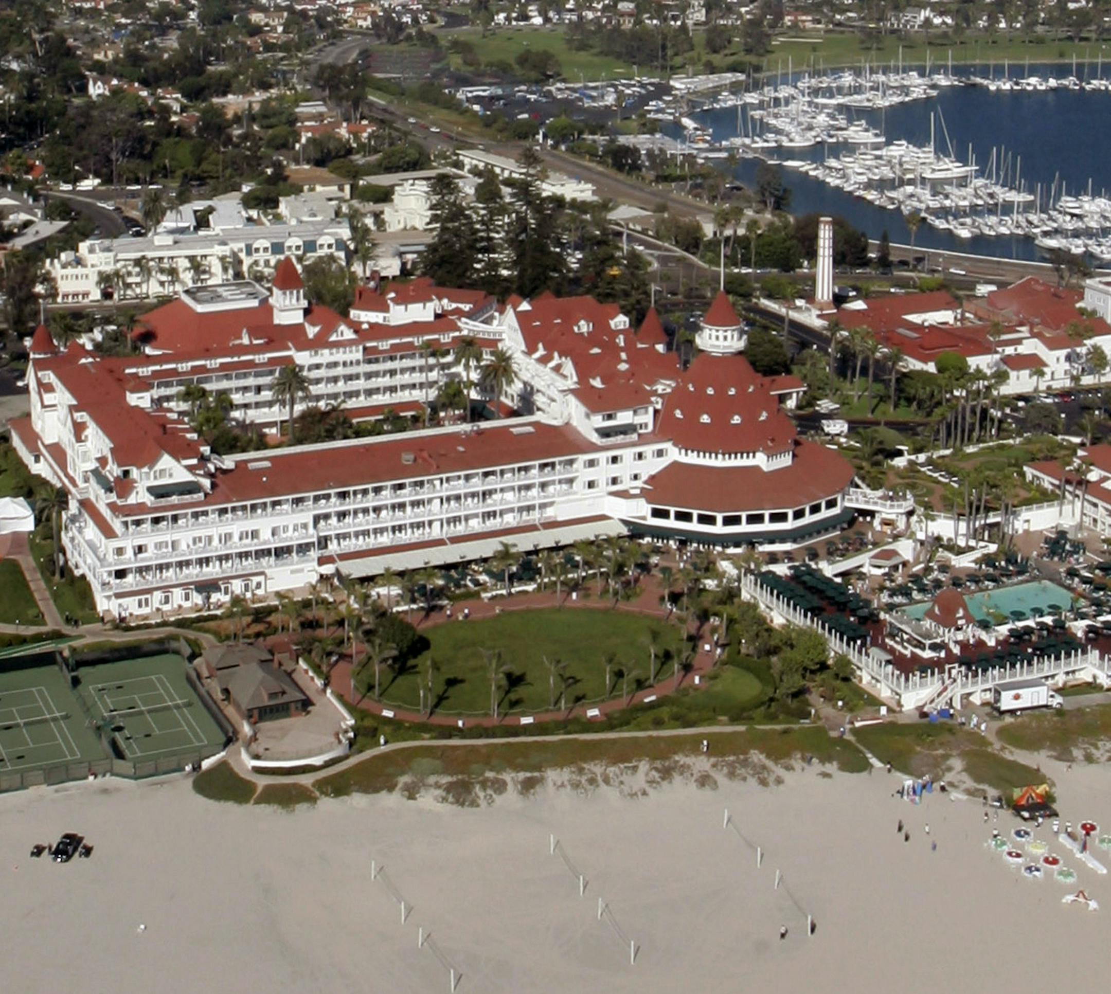 FILE - This Aug. 29, 2005, file photo, shows an aerial view of the historic Hotel del Coronado in Coronado, Calif. Southern California's historic Hotel Del Coronado could temporarily cut up to 160 employees as it prepares to shut down boutiques, a restaurant and its spa amid renovations. The San Diego Union-Tribune reports Thursday, Oct. 31, 2019, the beach resort notified the state it may have to lay off 10% of its workforce. But the hotel tells the Employment Development Department it's possib