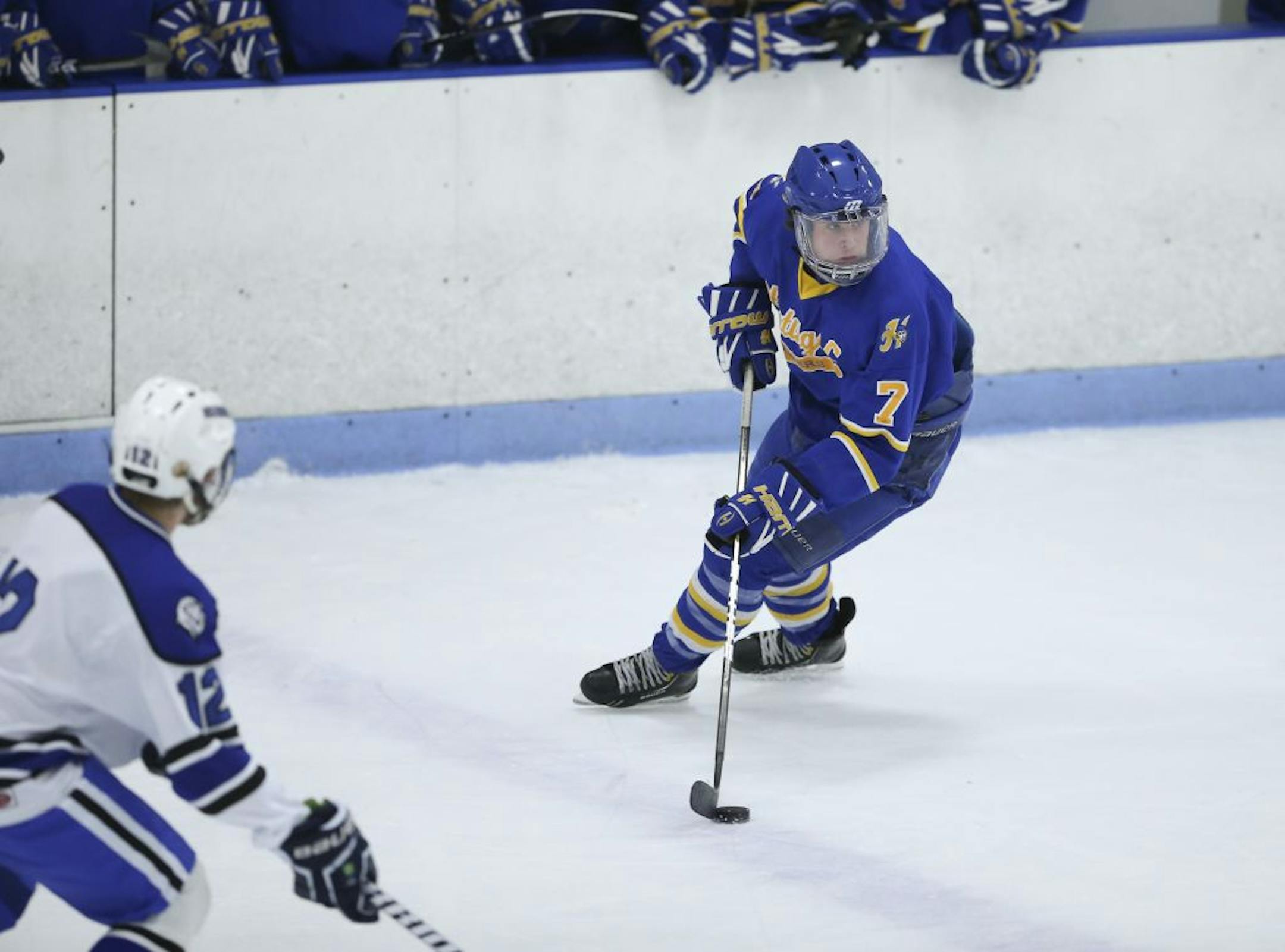 Hastings defenseman Matt Koch looked for a teammate as he moved the puck across the Woodbury blue line in the second period of a 9-3 Raiders victory Tuesday night. Photo by Jeff Wheeler • jwheeler@startribune.com